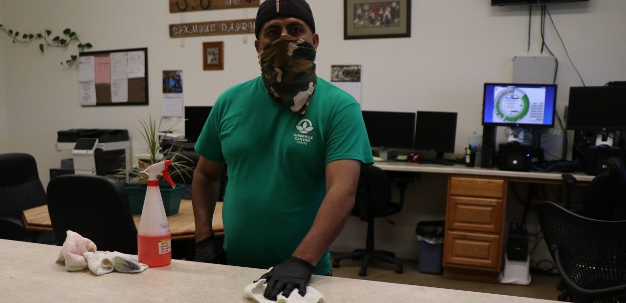 man in mask cleaning in office